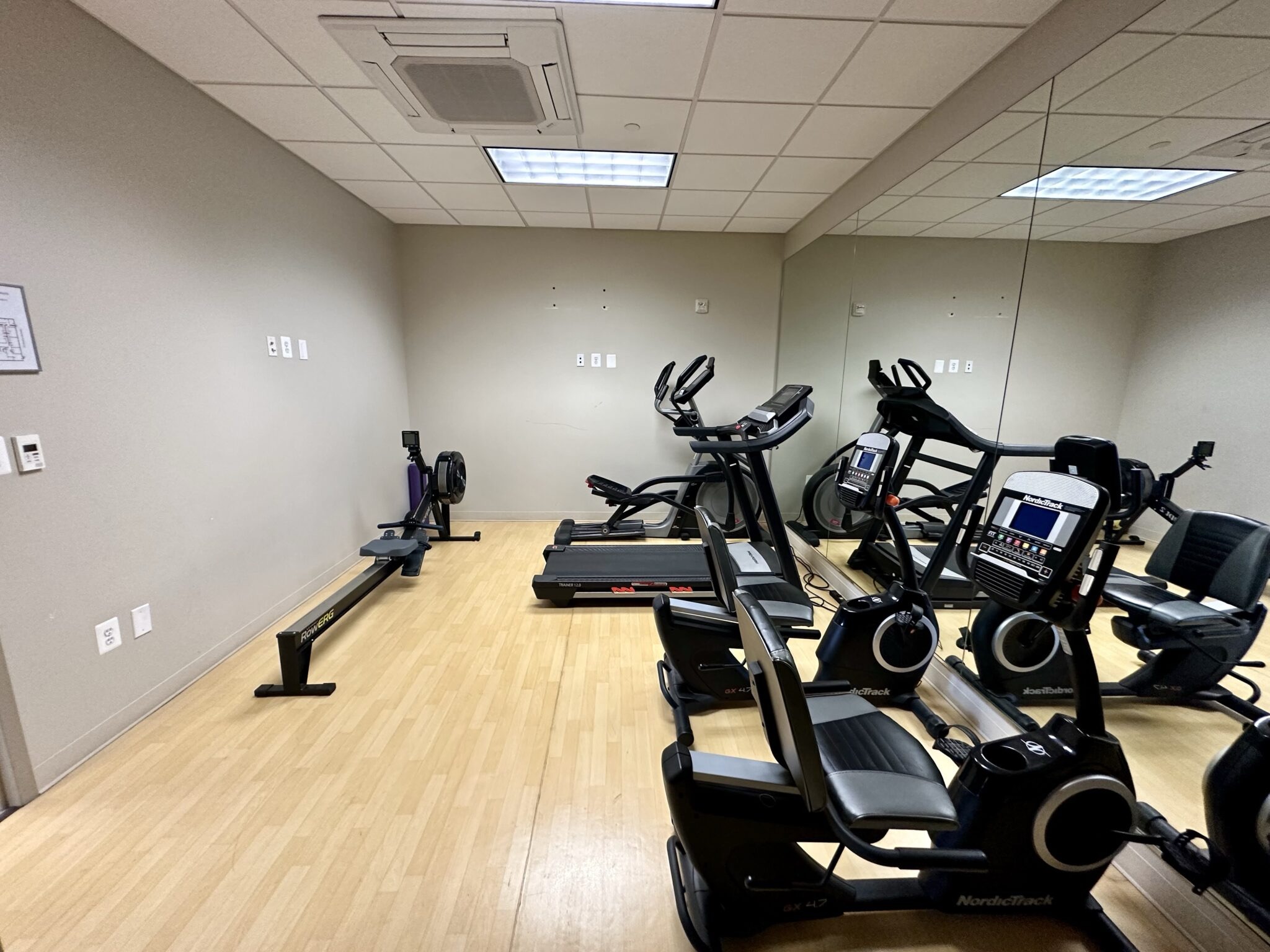 The exercise room at Le Yuan, with treadmills, ellipticals, and stationary bikes