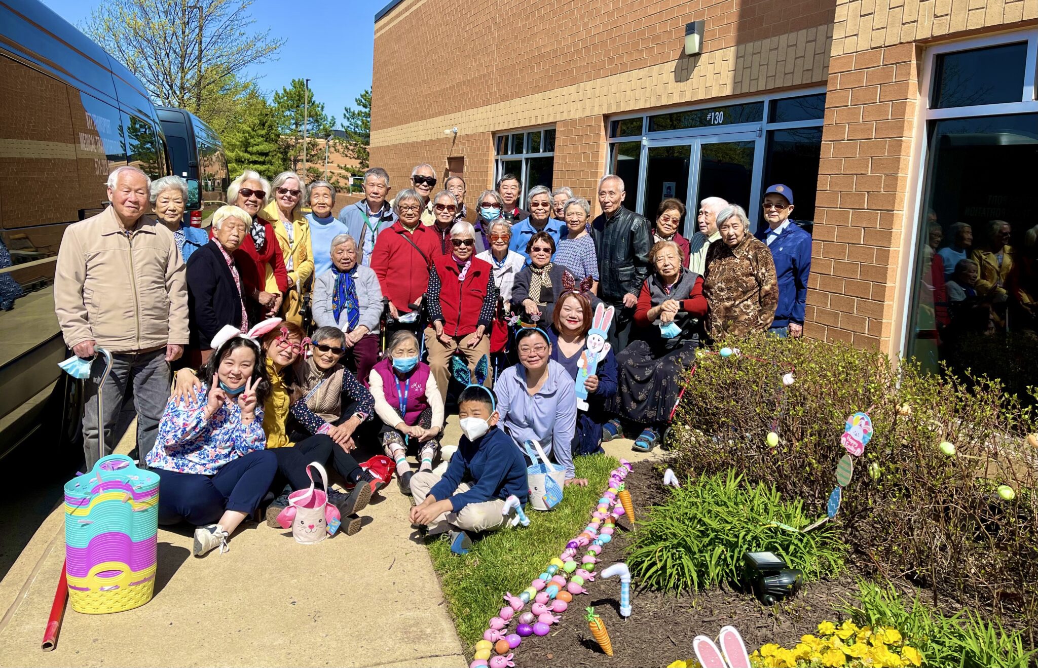 Staff and seniors celebrating a spring outing with Easter decorations