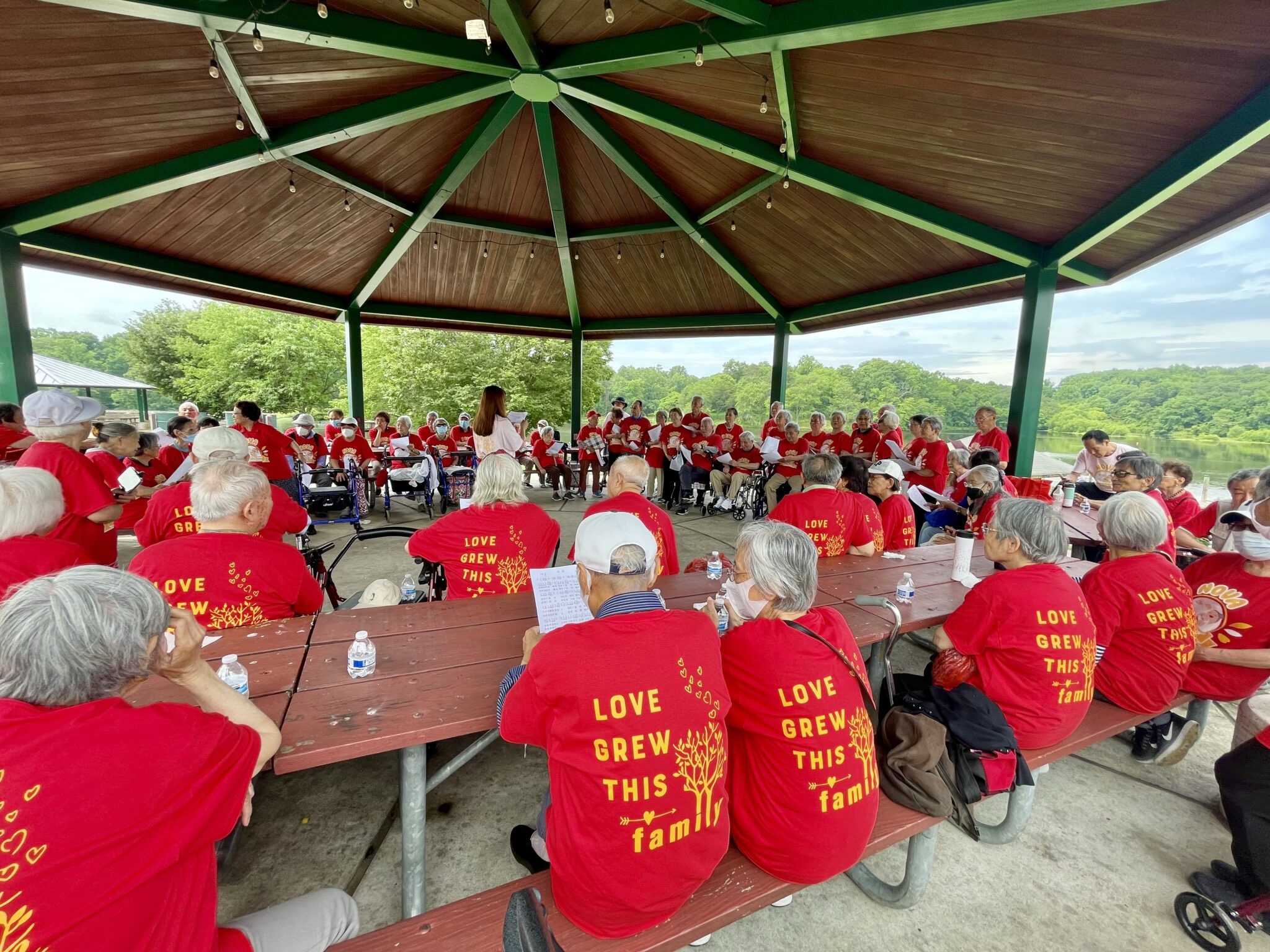 A close-up of seniors in matching shirts at a lakeside celebration